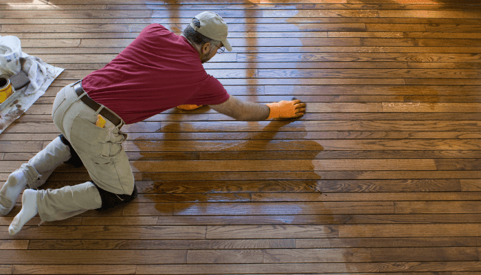remodeling ideas for a fixer upper man refinishing a wood floor