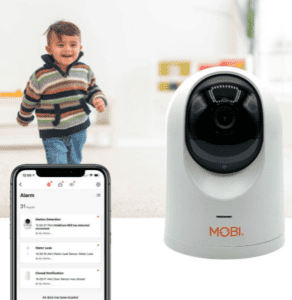 little boy and baby monitor with cell phone app opened on phone