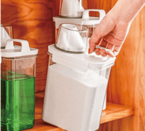woman holding laundry detergent clear plastic container