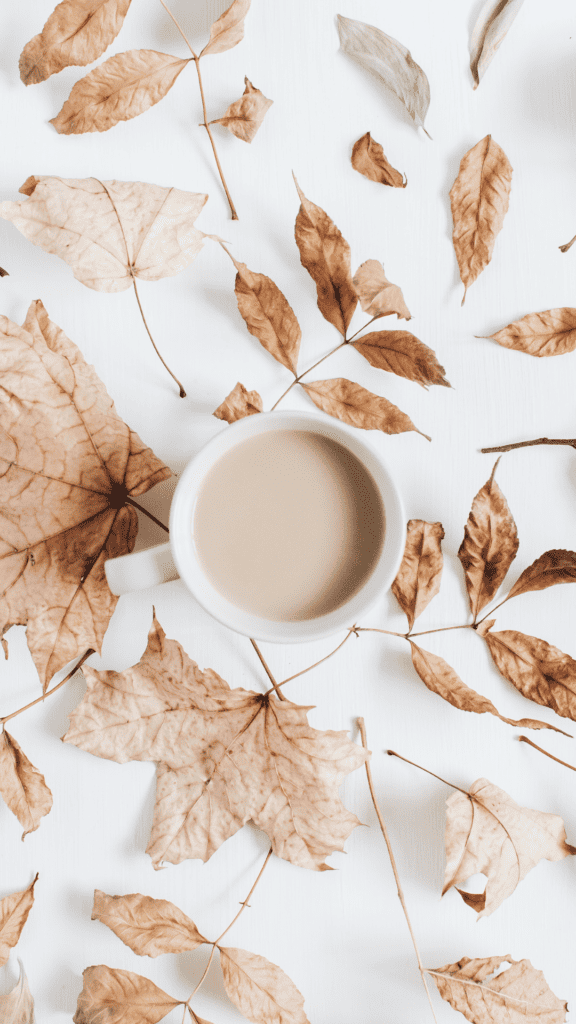 cup of hot chocolate among leaves