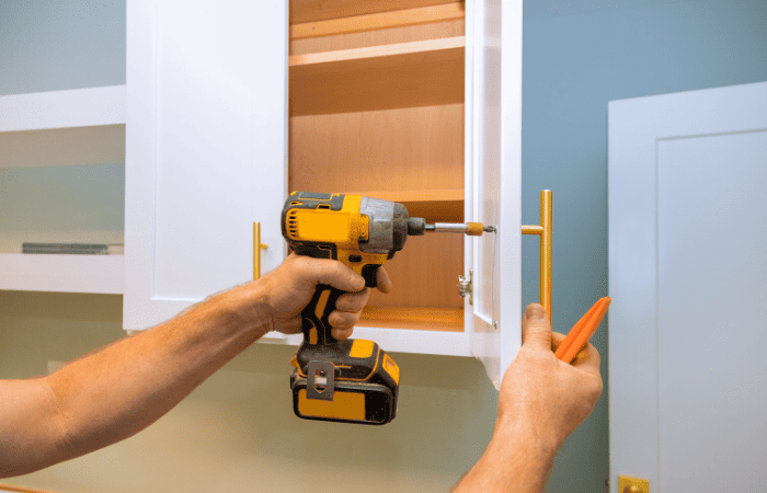 how to upgrade rental property person changing fixtures on cabinets