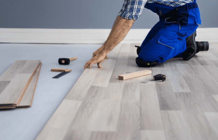 rental renovation ideas man laying wood flooring