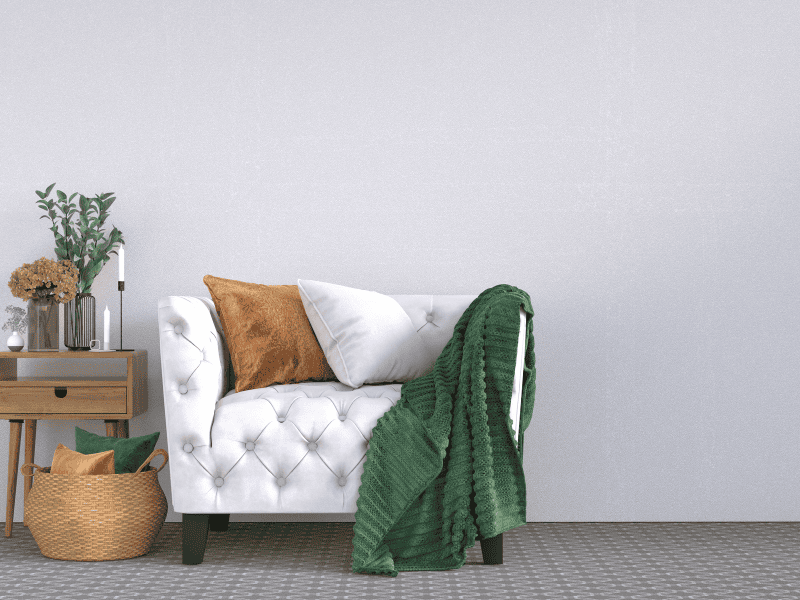 combining textures from chair, to throw pillows and throw blanket on how to make furniture look expensive