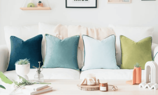 how to furniture look expensive by adding pretty throw pillows