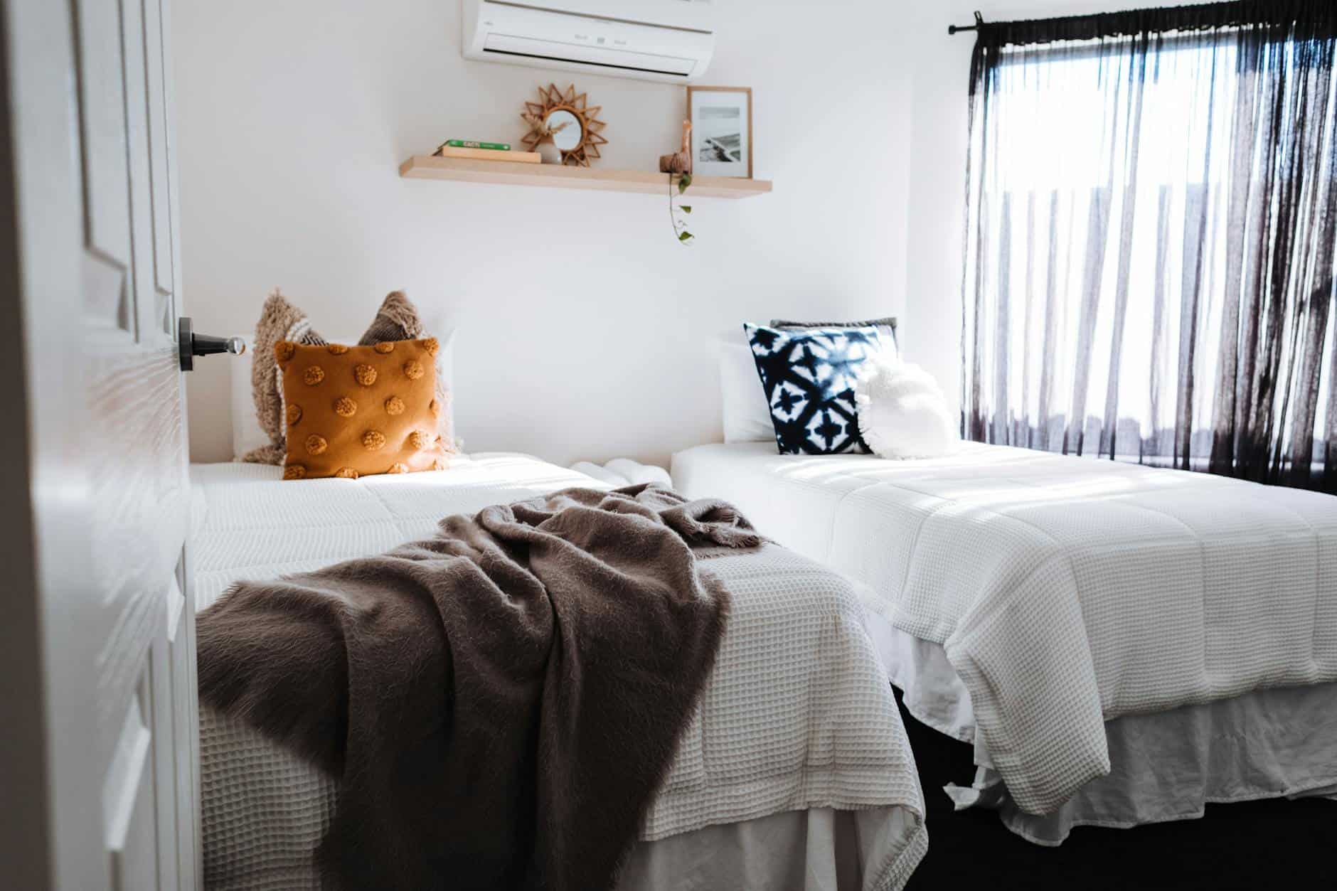 separate beds in bedroom in sunlight