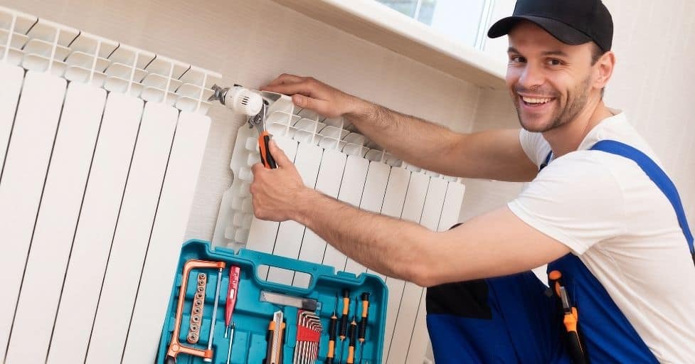 man installing smart thermostat